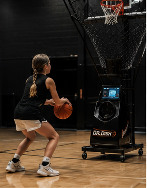 An athlete shooting into a Dr. Dish rebounding machine.