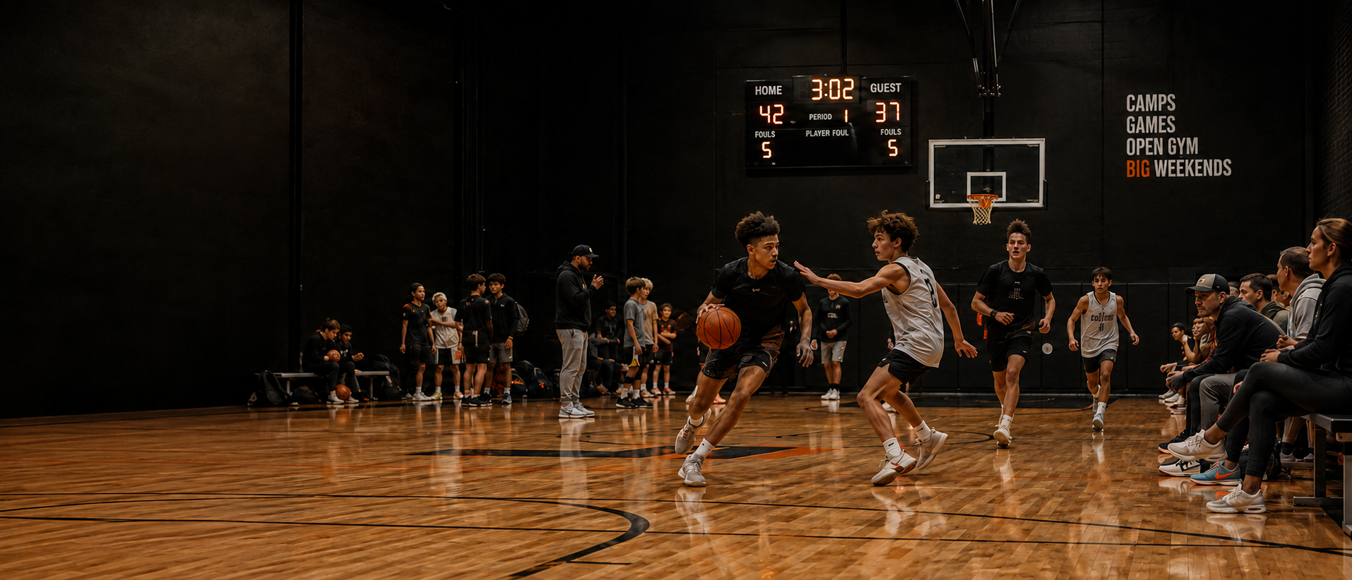 A player drives past a defender during a game at The Courts, with the scoreboard and 'The Courts' wall signage in the background.